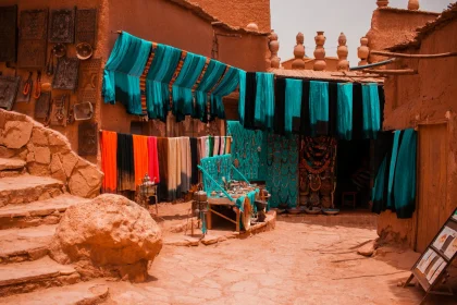 Best souvenirs Morocco buy - assorted-color textiles hanged beside concrete buildings