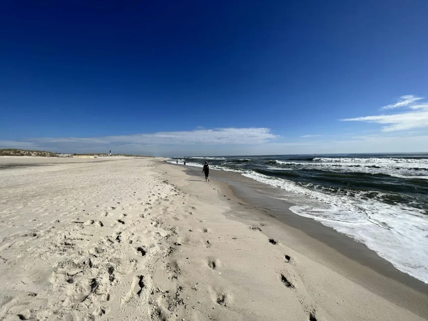 Ocean Beach Fire Island Travel Guide, Fun Things to Do - a person walking on a beach