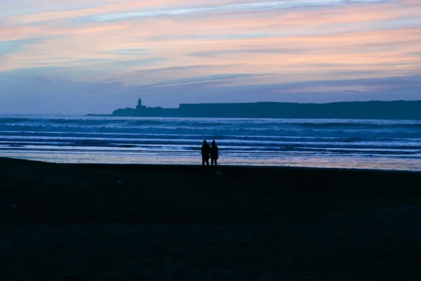 Morocco romantic escapes couples - A couple stands silhouetted on a