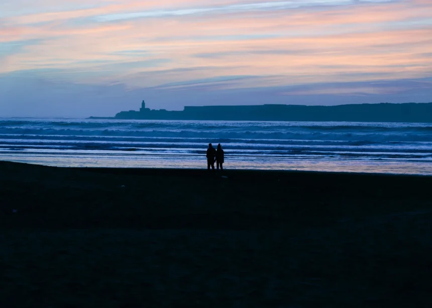 Morocco romantic escapes couples - A couple stands silhouetted on a