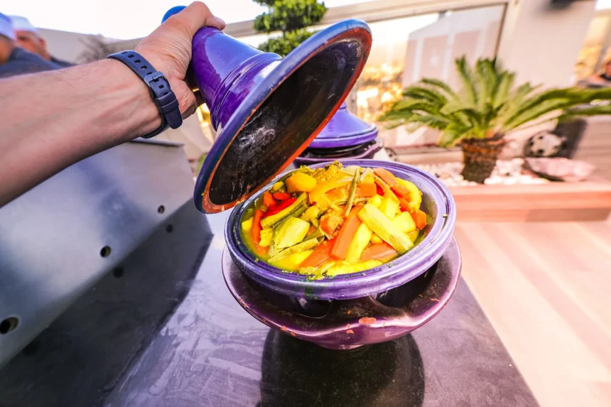 Moroccan cuisine guide - Vibrant vegetable tagine being uncovered in